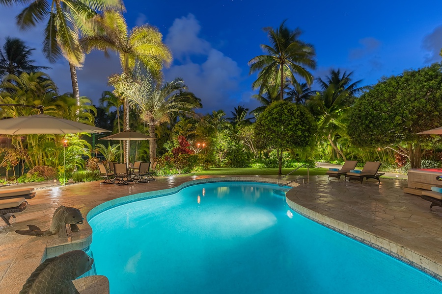 Relax by the sparkling pool surrounded by lush tropical greenery.