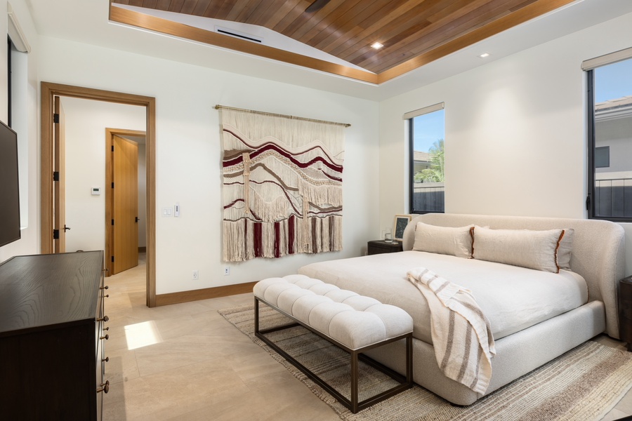 Relax in the downstairs primary suite (Bedroom 3) with a plush king-sized bed.