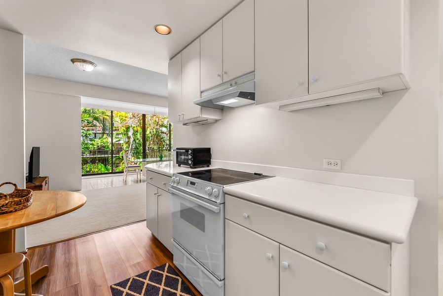 The kitchen has white cabinetry for extra storage.