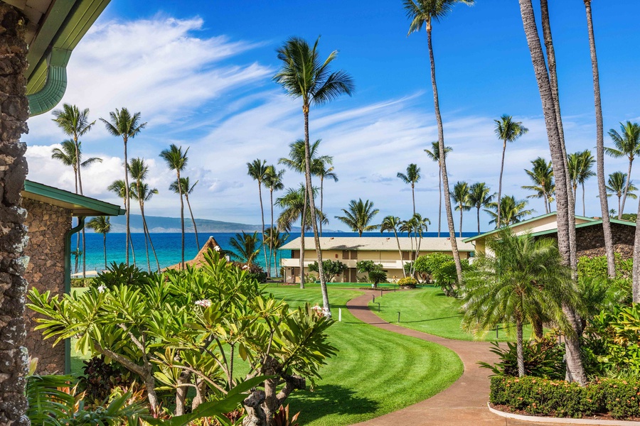 Partial ocean views and blooming plumeria await on the lanai of Napili Shores F-252.