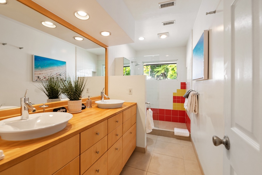 Shared bathroom separately accessed from the hallway with double vanities and shower between Bedrooms #4 and #5