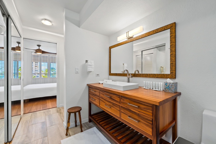 Spa-like bathroom with rich wood cabinetry, ambient lighting, and natural finishes—perfect for post-beach refreshment.
