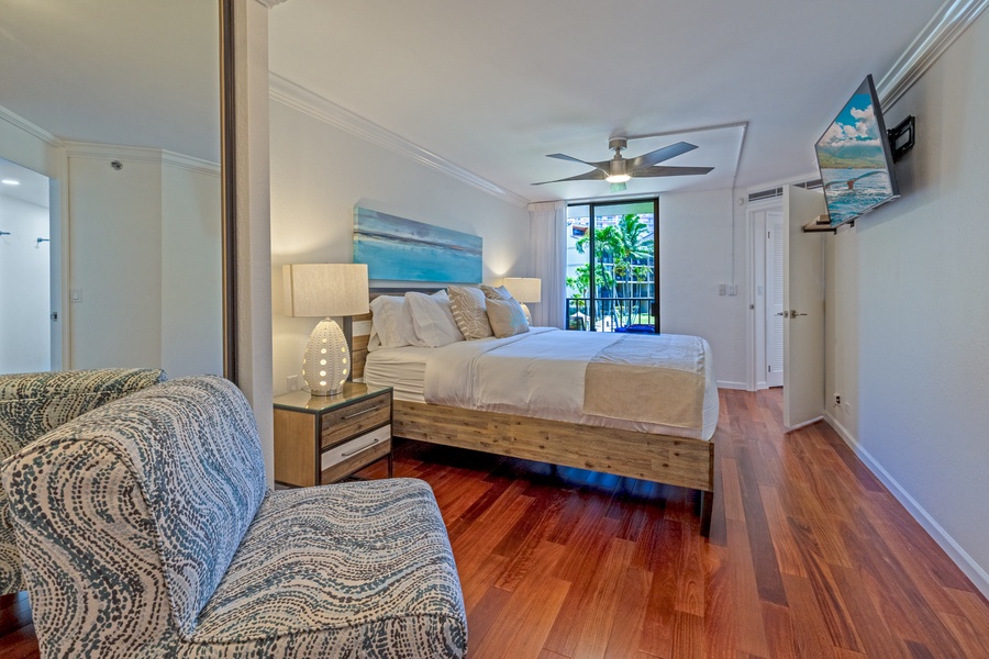 The spacious bedroom features a comfortable king-sized bed and access to a private lanai