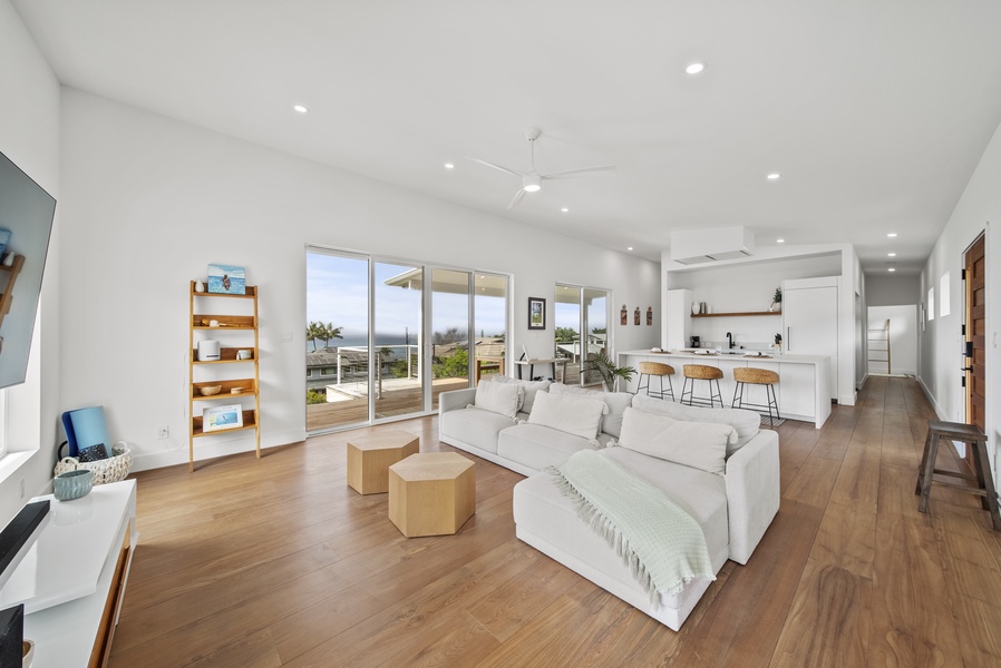 Lounge in the airy living area with seamless access to the outdoor lanai.