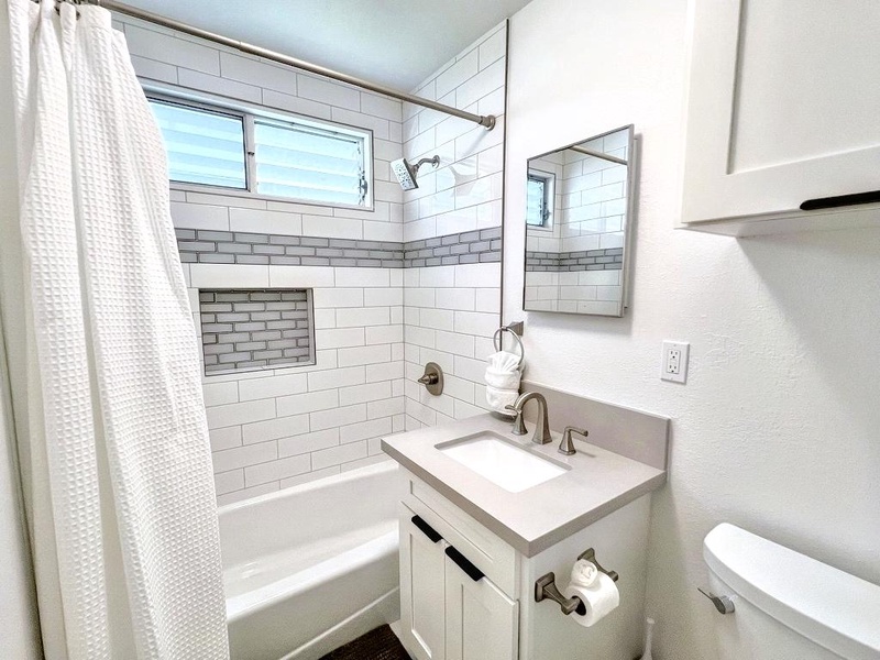 The guest cottage full bath features a shower/tub combo and modern finishes for a comfortable stay.