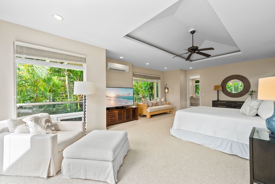 Your spacious master suite features crisp linens, tropical garden views, and a cozy seating area for ultimate relaxation.