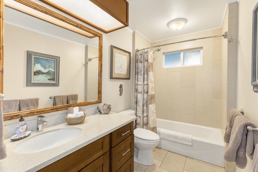 Shared bathroom with ample vanity space.