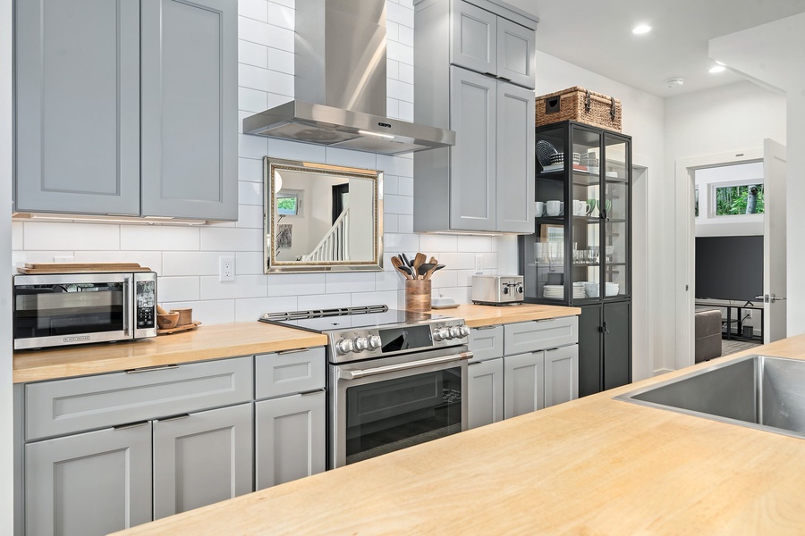 Effortless and functional—cook and connect in this clean-lined kitchen with modern appliances and open shelving.