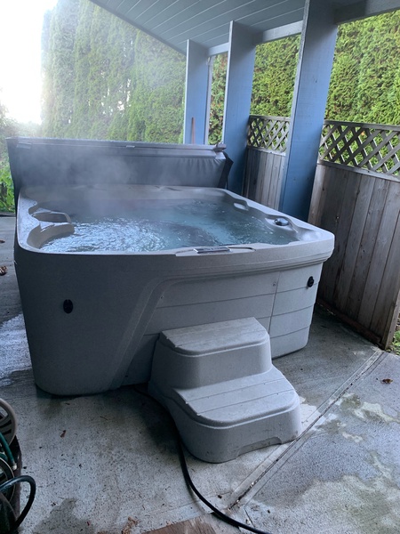 Private outdoor hot tub ready to provide a luxurious soak, nestled in a secluded space for ultimate relaxation and rejuvenation.