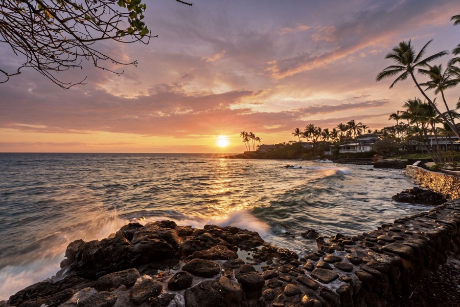 Golden light washes over the shoreline as waves roll in at dusk.