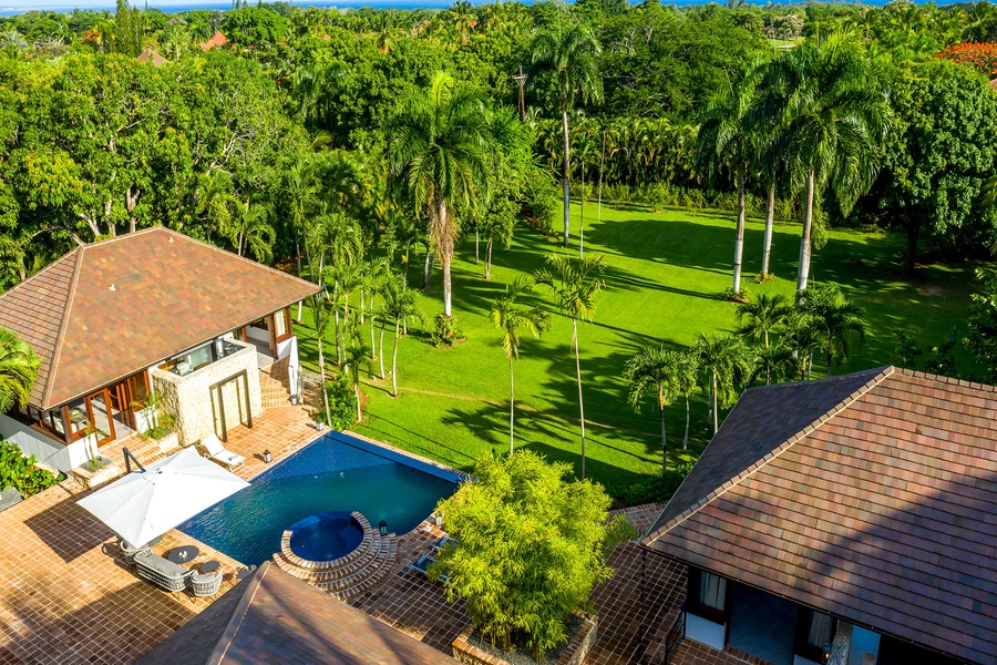 Bask in the beauty of the garden views, complete with a sparkling pool and palm trees.