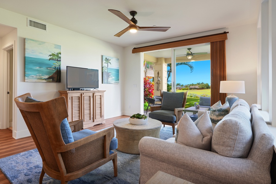Inviting living space with comfortable seating, a flatscreen TV, and views through sliding glass doors.