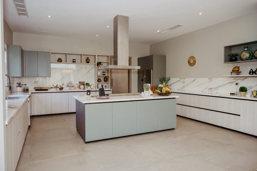 The kitchen equipped with state-of-the-art appliances, ample counter space, and a central island for meal prep.