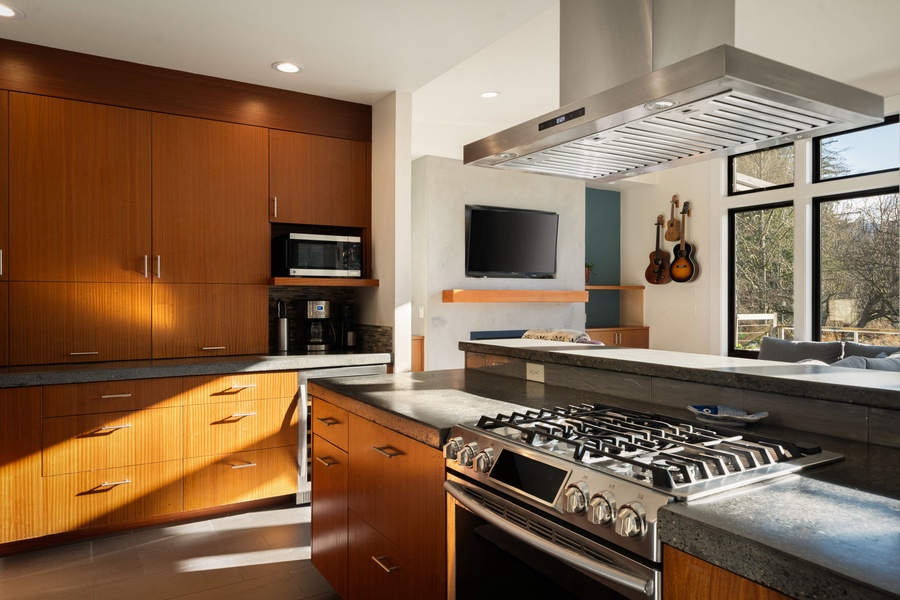 Gourmet kitchen awaits with sleek wood cabinetry, professional-grade appliances, and granite countertops perfect for culinary adventures.