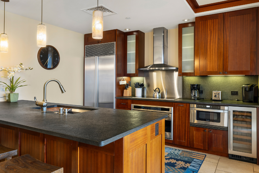 Alternate view of the kitchen with top of the line appliances and breakfast bar.