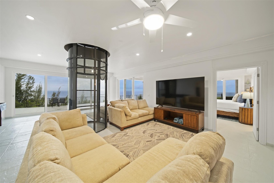 Great room (2nd floor) with wraparound lanai and elevator between the estate’s three stories.