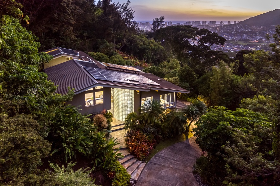 Private guest wing tucked into nature, lit beautifully for serene evening returns.