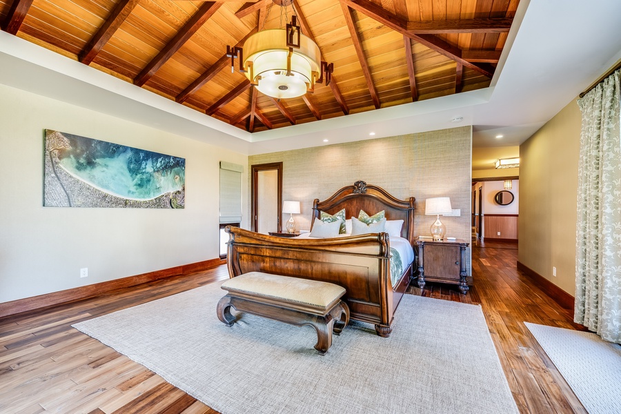 One of several ensuite guest bedrooms featuring vaulted ceilings and warm wood finishes.