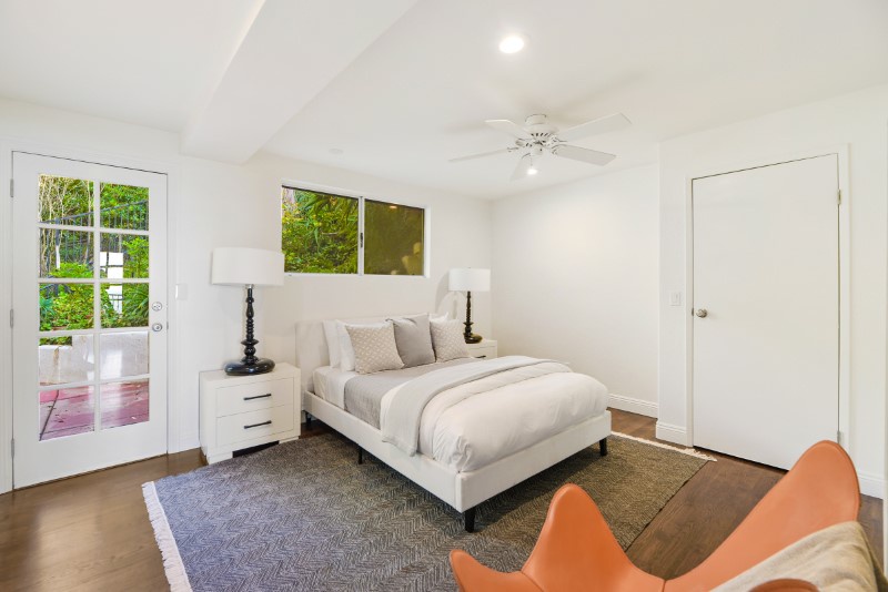 Drift into sweet dreams on a plush queen bed amidst the serene white finish of Bedroom 1