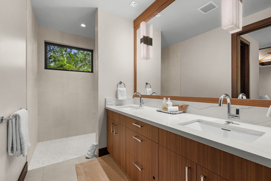 Guest Bedroom #3: Relax in your spa-inspired ensuite with a dual vanity, refined wood accents, and peaceful glimpses of the garden outside.