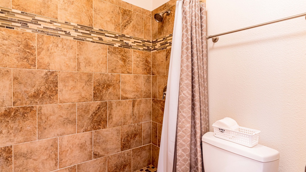 Relax and unwind in this spacious primary guest bathroom.