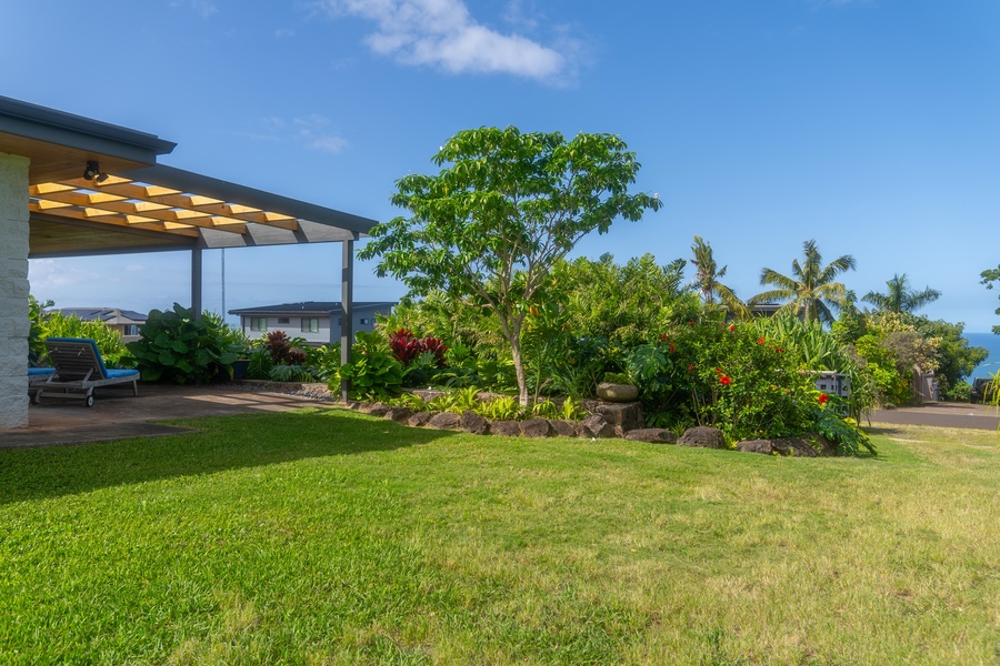 This lush backyard offers plenty of space to relax and enjoy the outdoors.