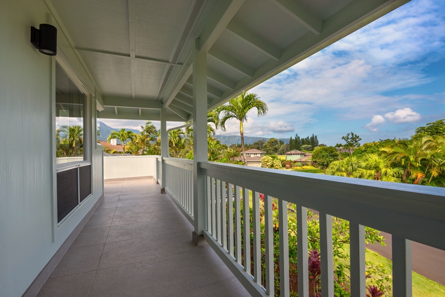 Spacious balcony overlooking the garden and distant hills.