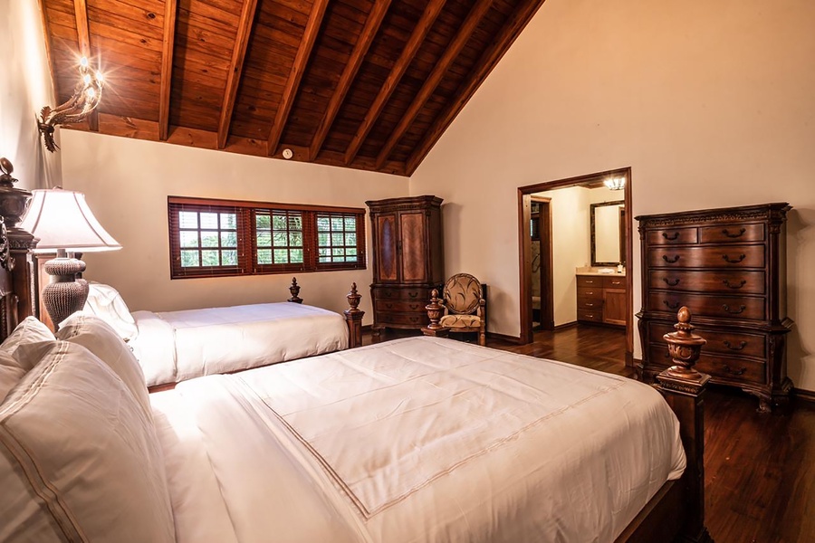 Large wooden windows allowing natural light, seating area and a wooden closet
