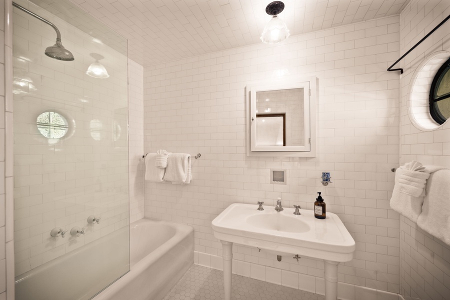A clean, bright bathroom with a rainfall shower, soft towels, and everything you need to refresh and unwind.