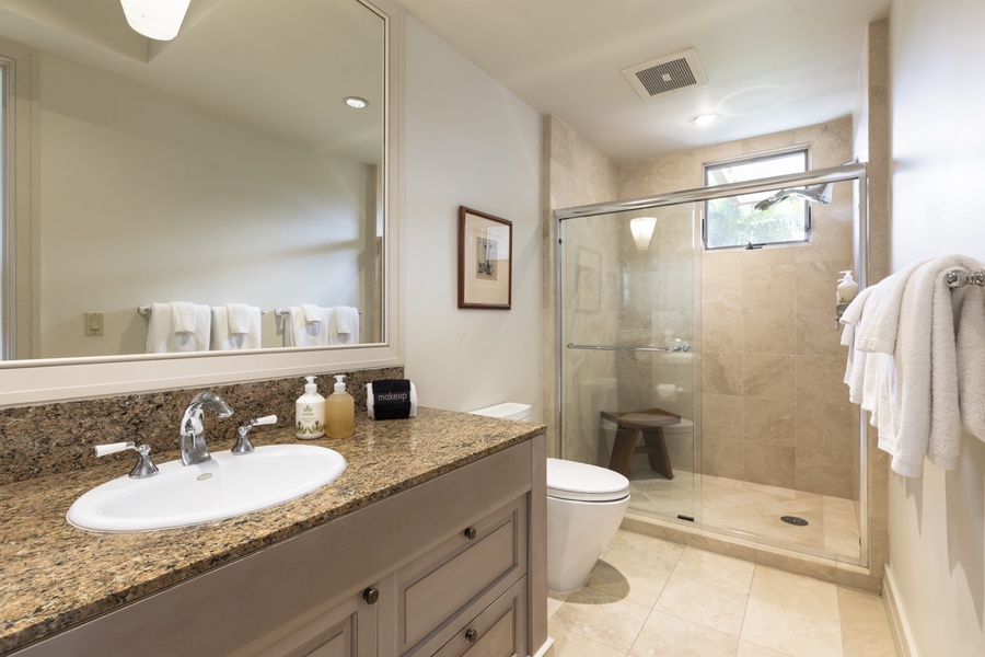 Adjacent to the third bedroom is a full bathroom with a walk-in shower
