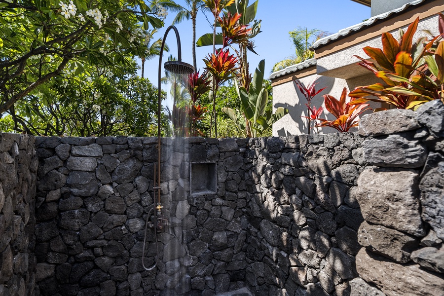 Outdoor shower is in a small courtyard outside of the downstairs guest bedroom