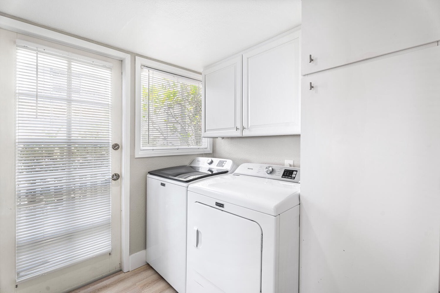 Full-sized washer and dryer conveniently located in the laundry room.