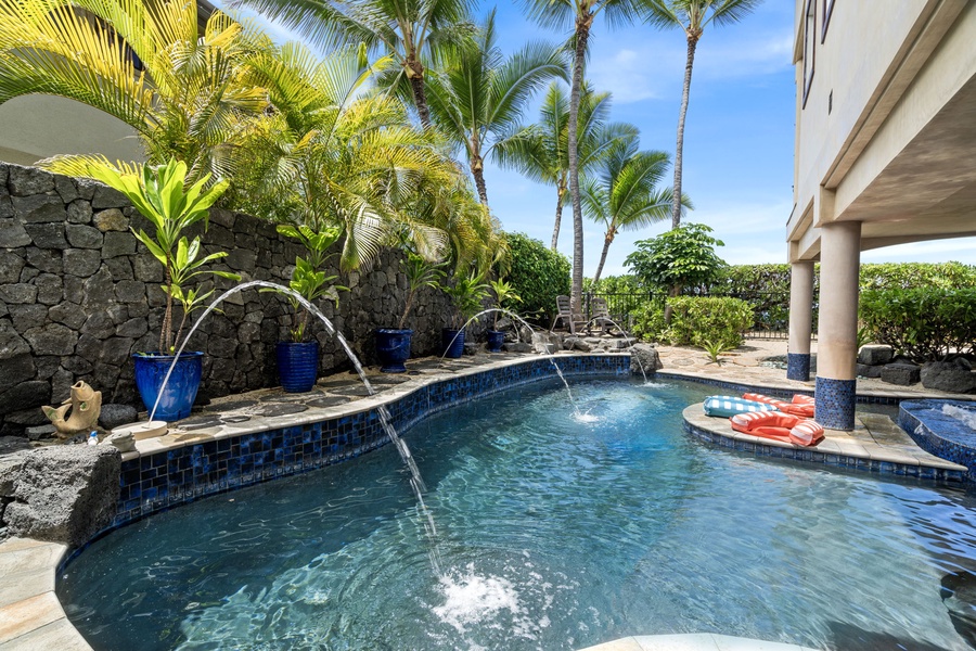 Tropical pool with arching fountains and spa spillover—your personal backyard waterpark awaits.