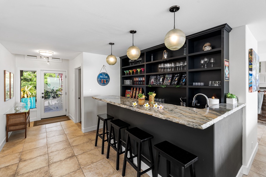 Gather around your private Tiki bar, ideal for cocktails, conversation, and connection.
