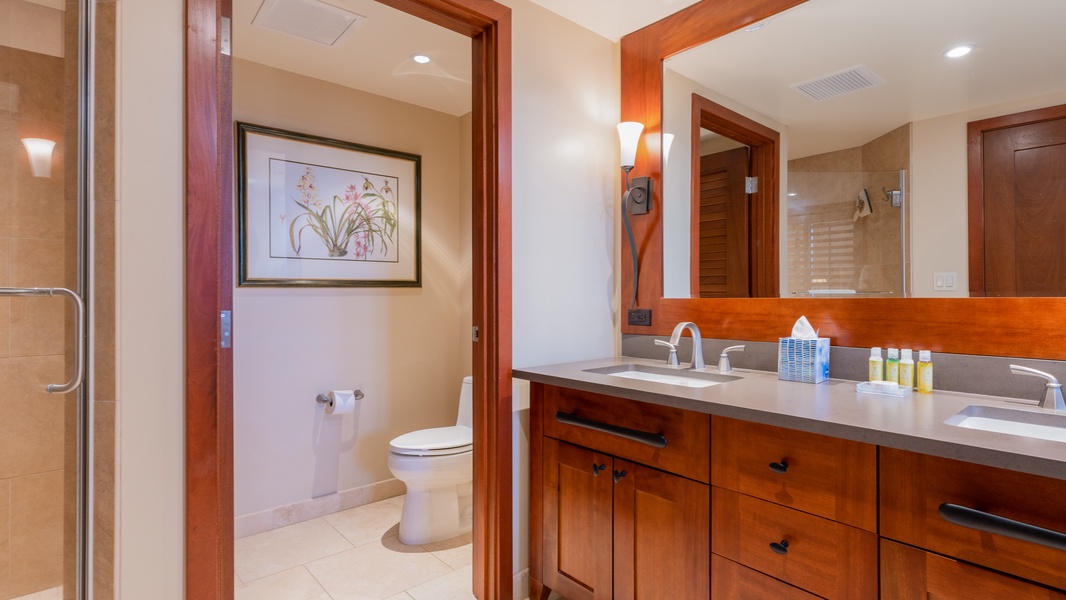 The primary guest bathroom has a double vanity and framed art.