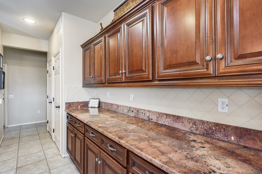 Master the art of cooking in a kitchen equipped with abundant cabinetry and storage solutions.