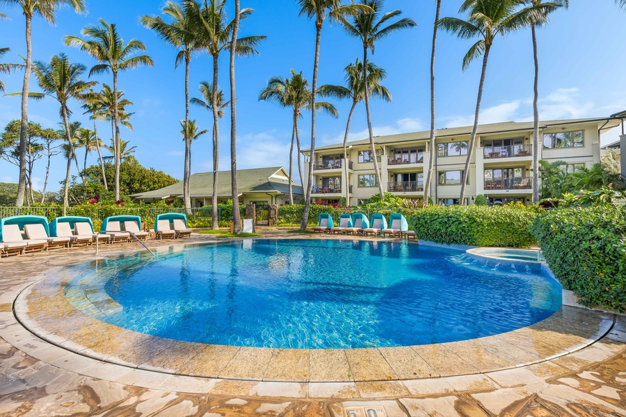 A sparkling blue pool surrounded by swaying palm trees offers the perfect tropical retreat for your Hawaiian getaway.