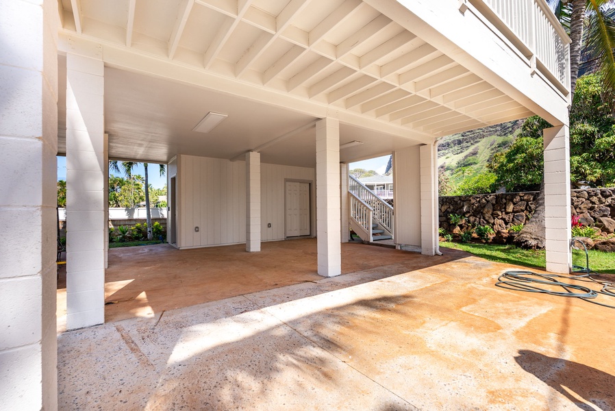 Covered lower-level carport and outdoor space for added convenience.