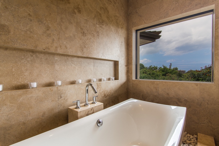 Bathroom two offers a large soaking tub with a view