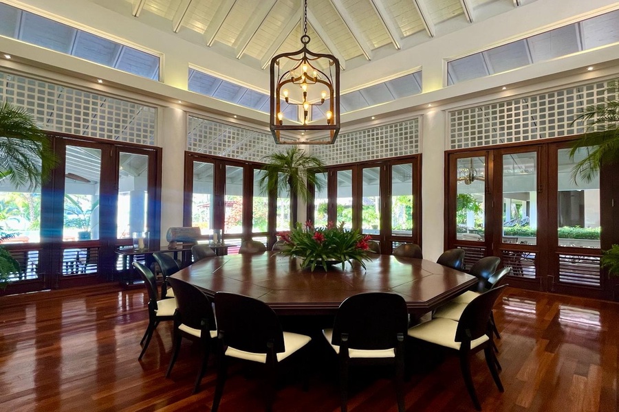 Elegant dining area with a large round table and stunning views of the outdoors.
