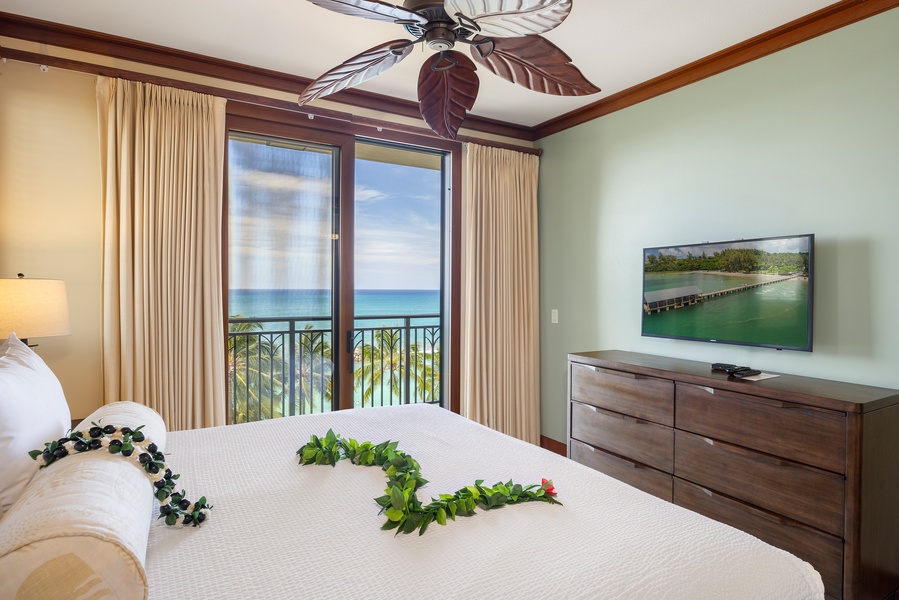 Wake up to stunning ocean views from your private lanai. The tropical ceiling fan and fresh island lei create perfect paradise vibes.