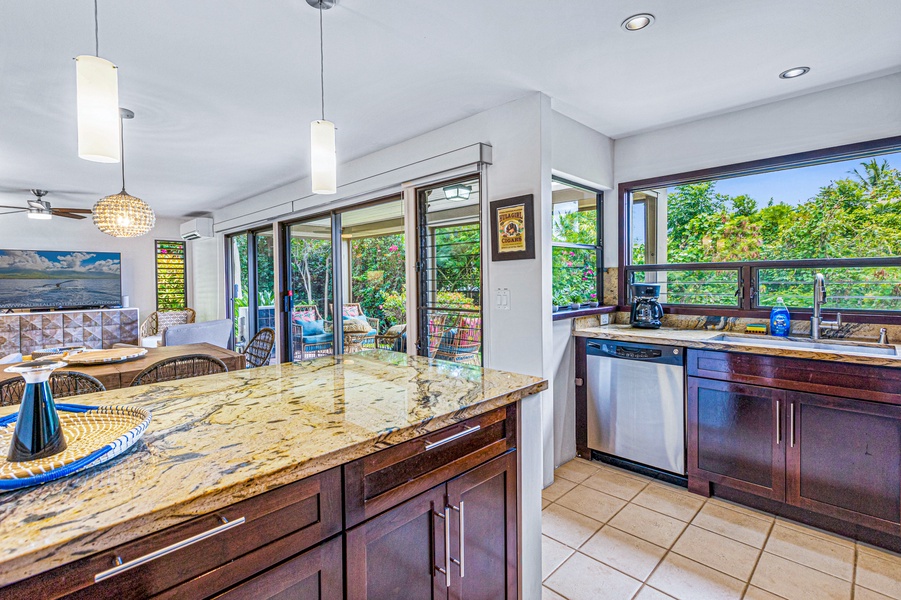Bright and airy, the kitchen and dining area in Wailea Ekolu 1605 provide seamless access to the lanai.