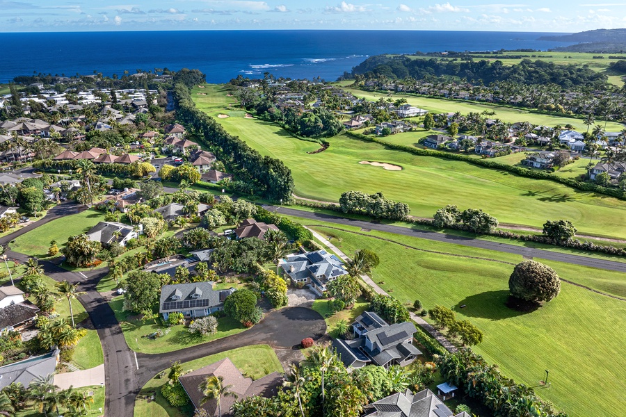 Stunning aerial view showcasing the coastal community with championship golf course, tropical landscaping, and pristine ocean backdrop.