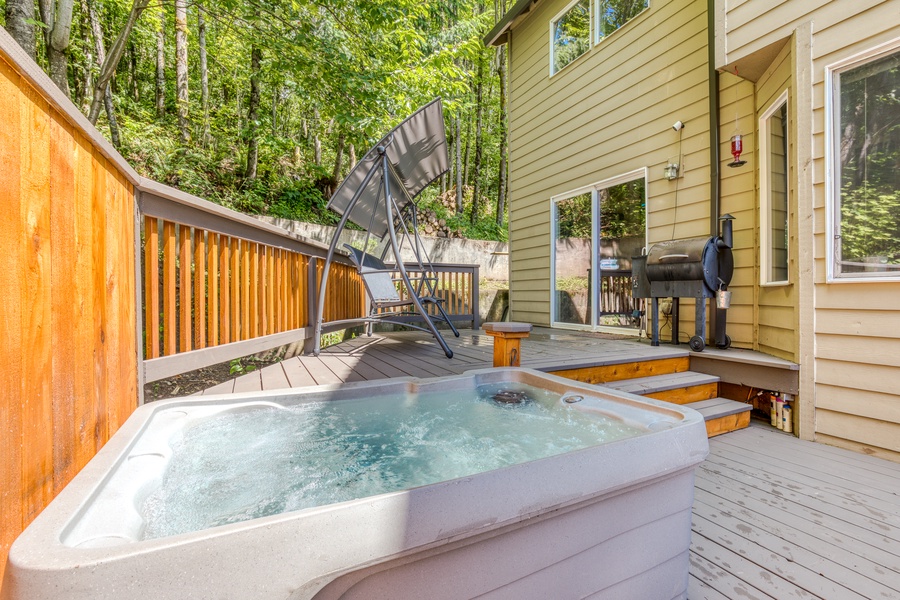 Enjoy time outdoors on the patio with a private hot tub, charcoal grill, outdoor seating, and fire pit