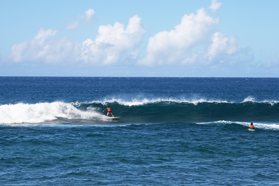 Watch skilled surfers ride the waves against a stunning backdrop at Kuhio Shores.