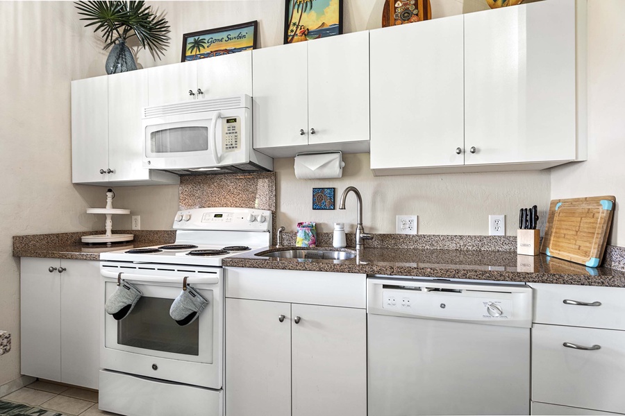 White finish cabinetry and ample appliances for the kitchen area