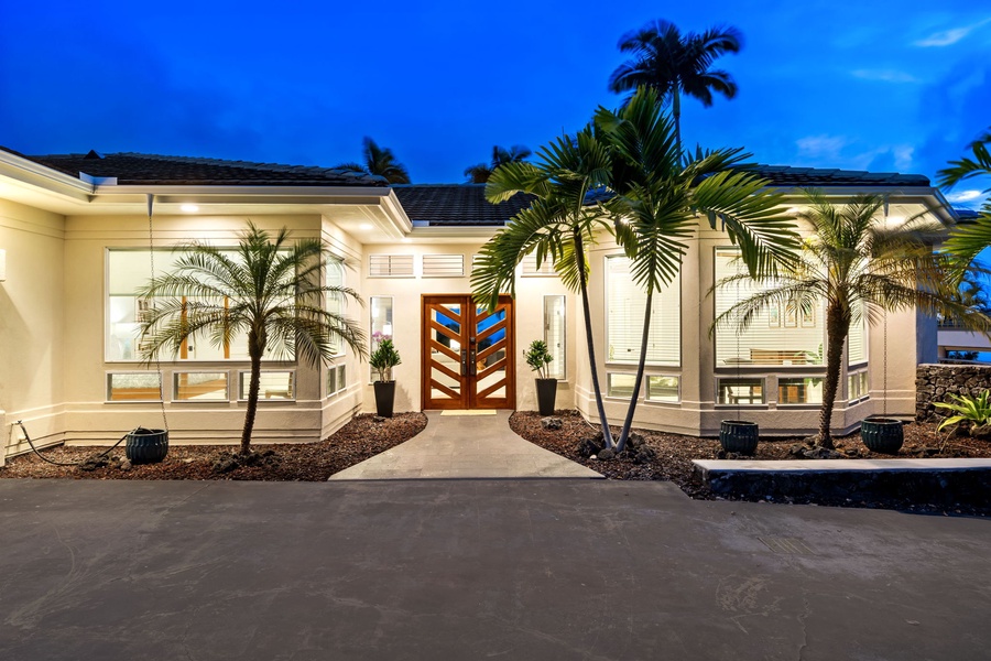 As evening sets in, the home radiates elegance and tropical warmth.