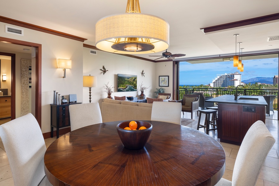 An open floor plan seamlessly connects the kitchen, dining, and living areas for effortless entertaining in this tropical retreat.