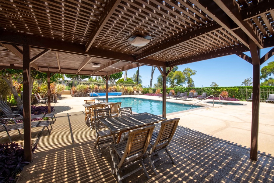 Dine in comfort under the pergola at Cabana A, where shaded tables offer the perfect spot to gather and relax poolside.
