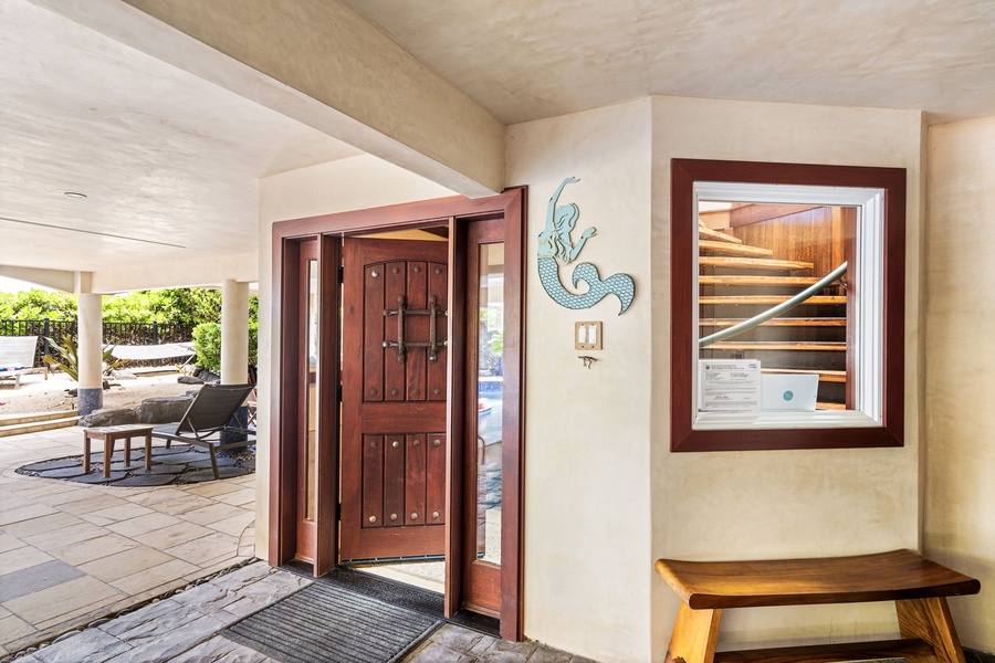 Covered entryway with custom tile and decor—Mermaid Cove hospitality starts the moment you arrive.